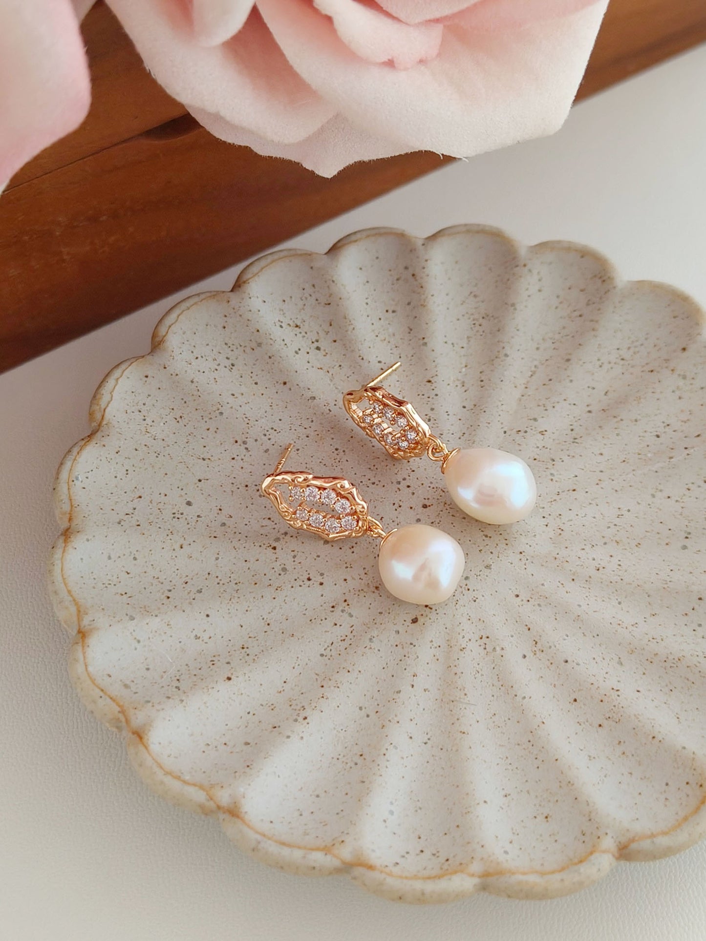 A secondary product angle focusing on the pair’s symmetry in quality despite their unique individual shapes, targeting customers seeking handcrafted artisan earrings with a high-end aesthetic.