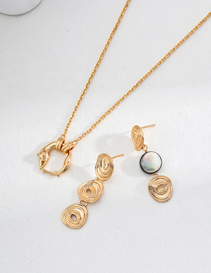 A curated flat lay of the Nyx earrings paired with a matching cosmic-themed pendant, perfect for creating a monochromatic luxury jewelry set.