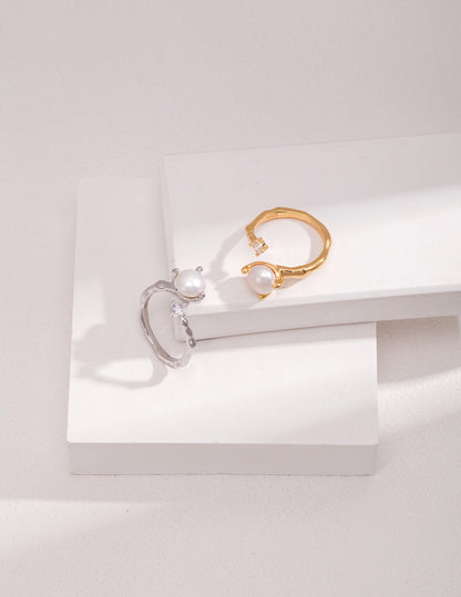 A high-contrast display of both the Gold and Silver Elora rings, illustrating the harmony of the mixed-metal collection for versatile styling.