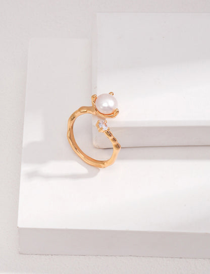 A professional studio shot of the Elora ring in Vintage Gold, highlighting the warm 18K plating and the intricate zircon-studded organic band.