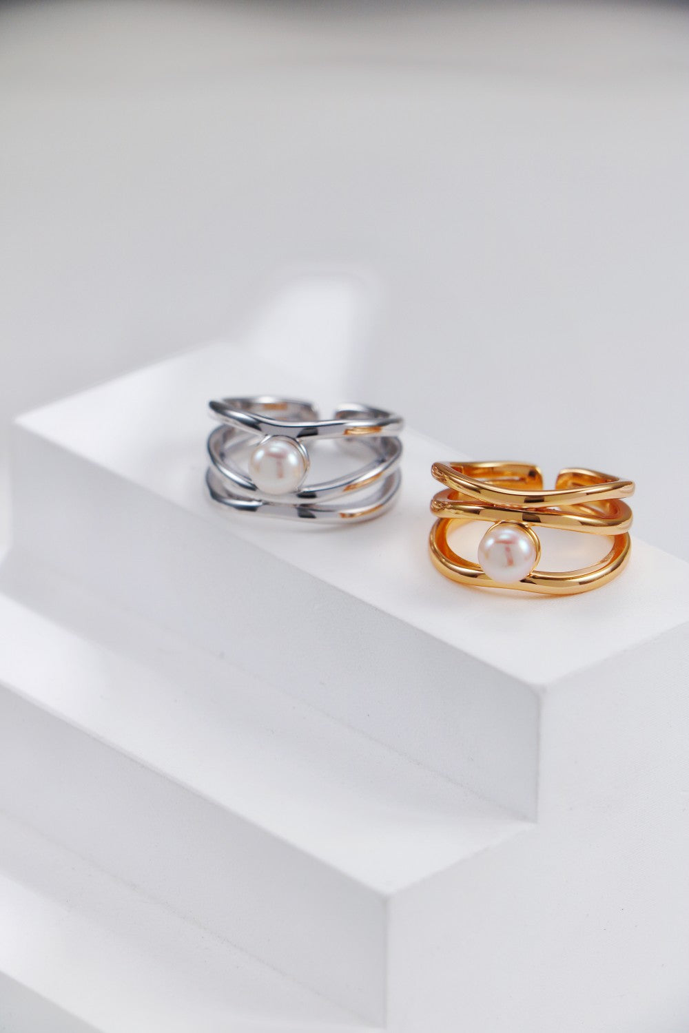 A creative flat lay of the vintage gold and platinum sets, showcasing the precision of the interlacing metalwork and the consistent quality of the hand-picked pearls.