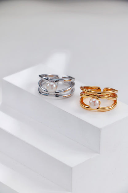 A creative flat lay of the vintage gold and platinum sets, showcasing the precision of the interlacing metalwork and the consistent quality of the hand-picked pearls.