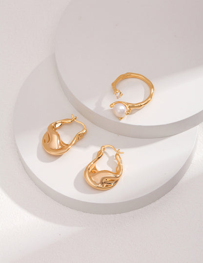 A captivating studio composition of the Elora jewelry suite, showcasing the flawless coordination between the zircon-encrusted pearl ring and the matching shimmering drop earrings, embodying a complete look of modern celestial elegance.