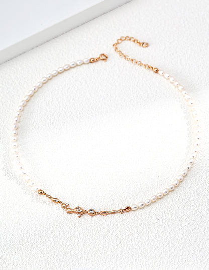 A professional studio shot of the Astra pearl necklace in vintage gold. This image highlights the "pearl-as-star" concept, showing the alternating pattern of natural 4*5mm pearls against the delicate silver chain.
