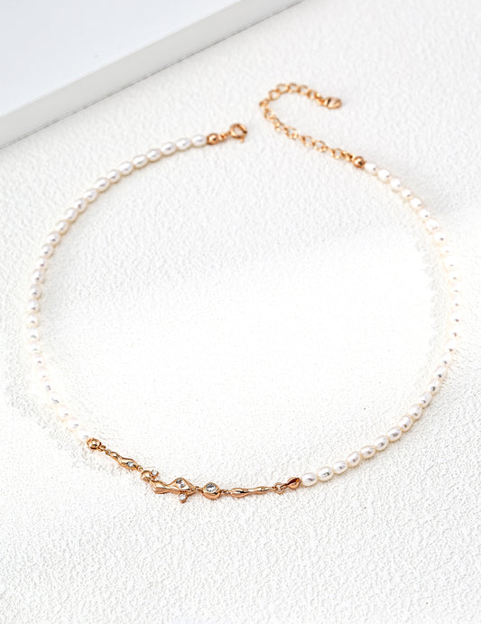 A professional studio shot of the Astra pearl necklace in vintage gold. This image highlights the "pearl-as-star" concept, showing the alternating pattern of natural 4*5mm pearls against the delicate silver chain.