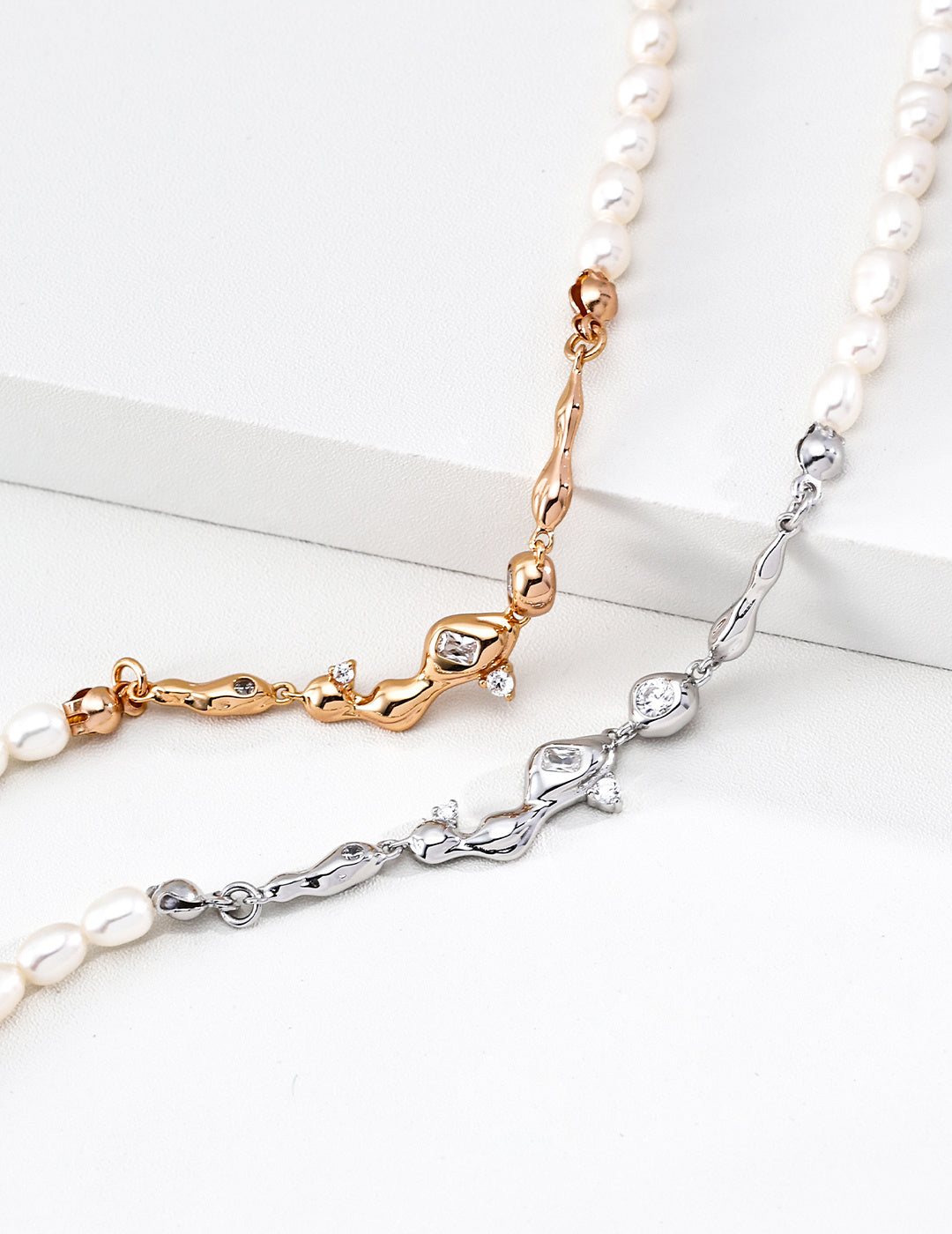 A macro close-up of the CZ star charms and the connection to the freshwater pearls. This visual highlights the precision of the hand-set cubic zirconia, reinforcing the brand's commitment to artisanal quality.