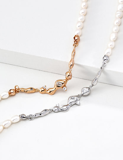 A macro close-up of the CZ star charms and the connection to the freshwater pearls. This visual highlights the precision of the hand-set cubic zirconia, reinforcing the brand's commitment to artisanal quality.