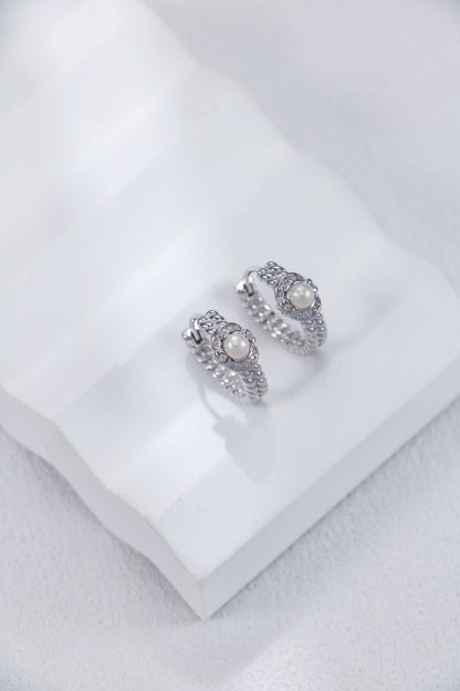 A side view focusing on the smooth, tapering metalwork and the secure, integrated hook design of the sterling silver pearl drops.