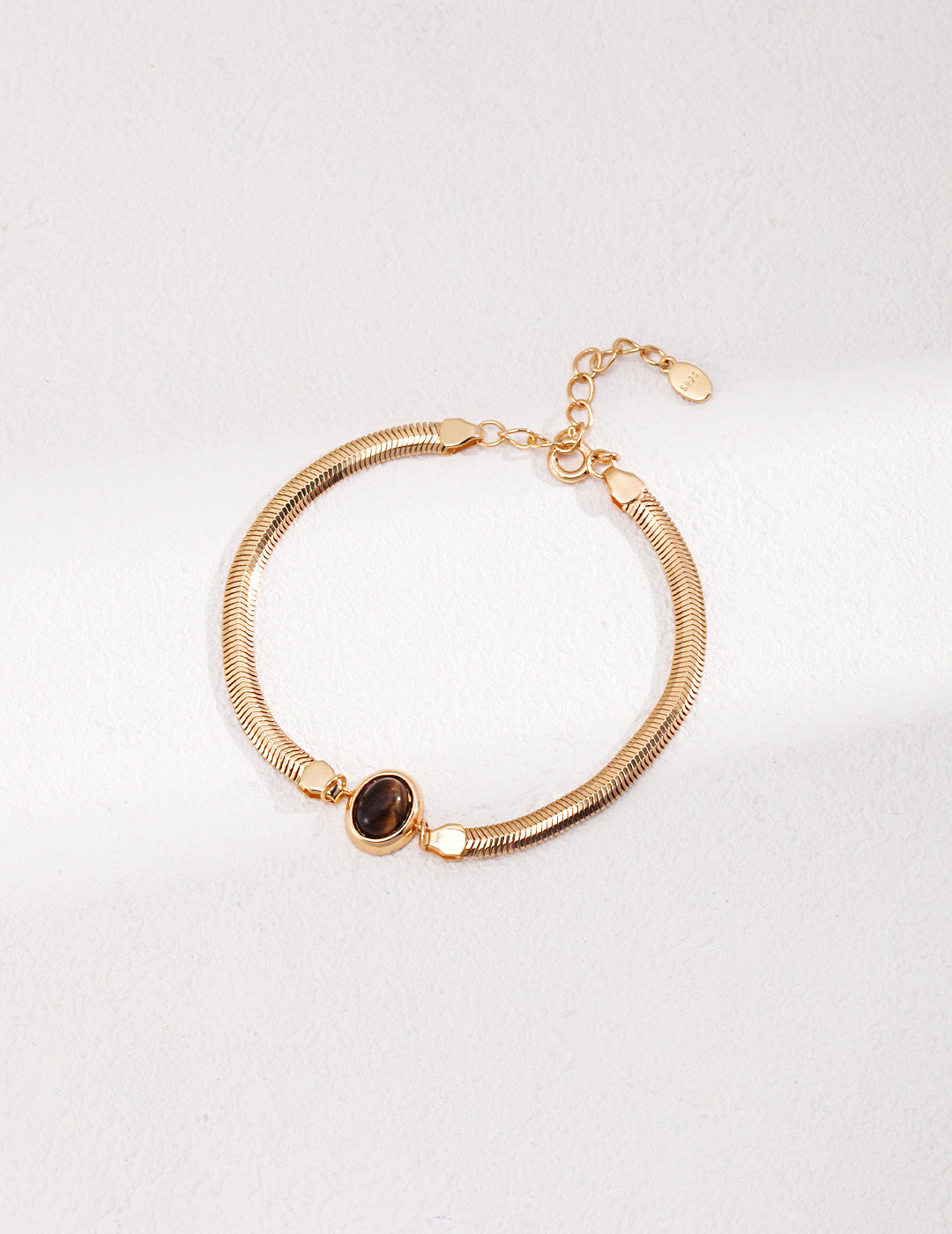 A professional studio shot of the Cyra bracelet in Vintage Gold, highlighting the warm, antique-inspired bezel setting that enhances the earth tones of the stones.