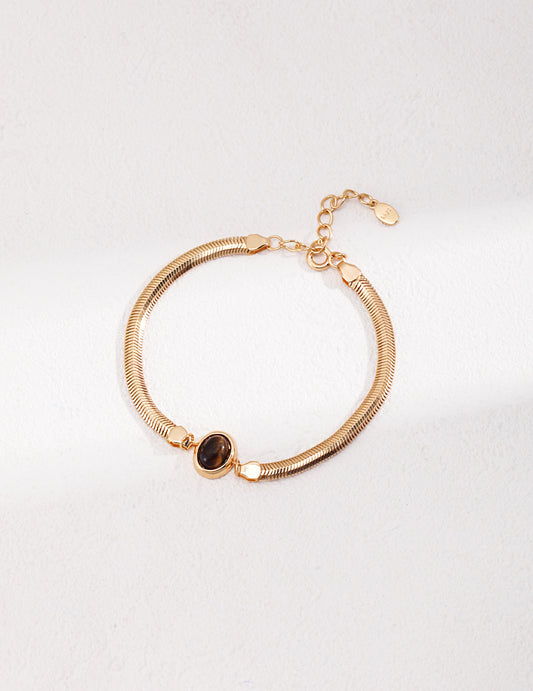 A professional studio shot of the Cyra bracelet in Vintage Gold, highlighting the warm, antique-inspired bezel setting that enhances the earth tones of the stones.
