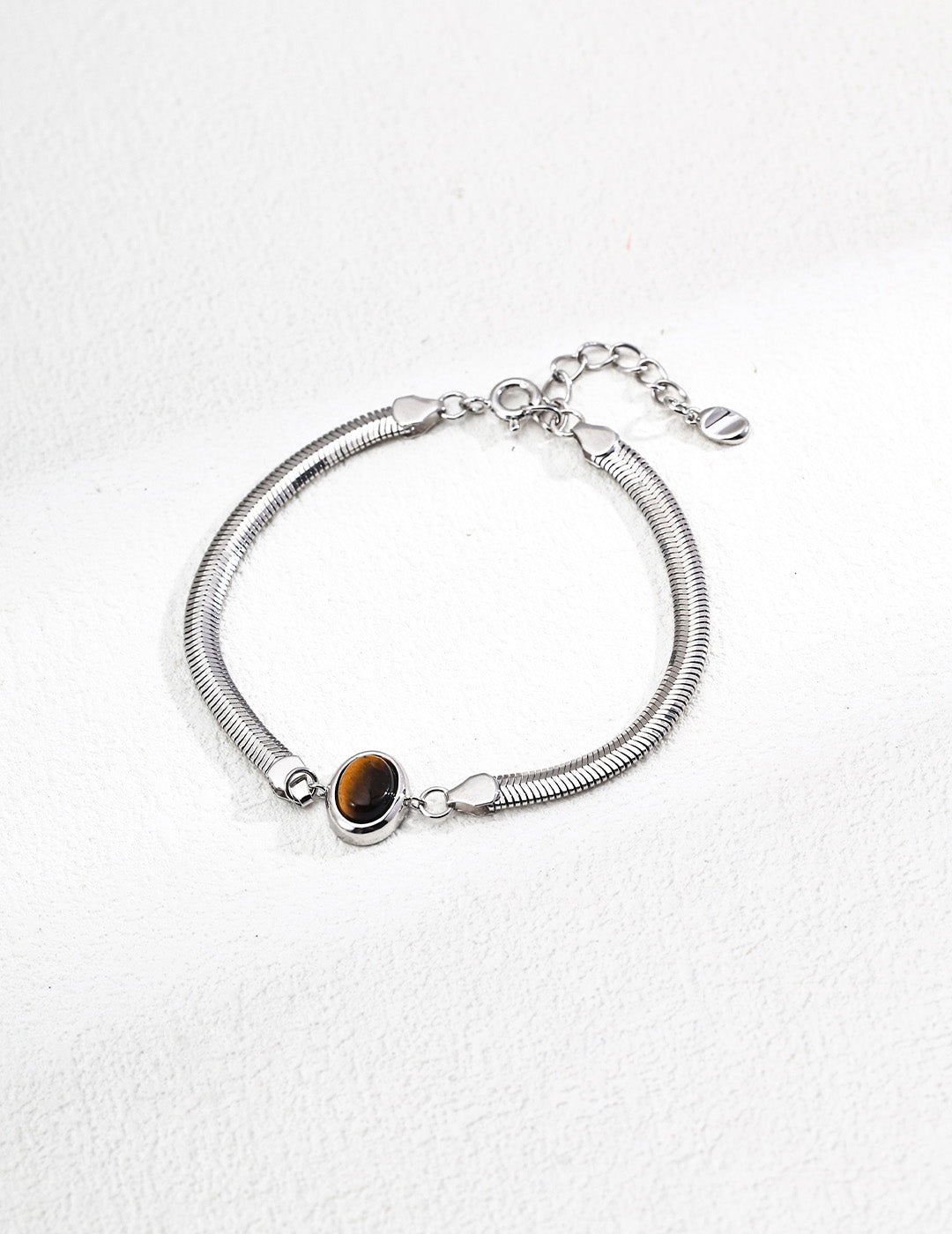 A high-definition shot of the Cyra bracelet in Platinum finish, offering a cool-toned, contemporary contrast to the vibrant natural gemstones.