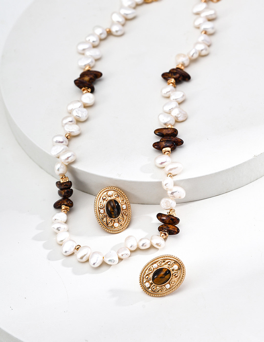 A curated flat lay featuring the Cyra necklace and matching bracelet. This visual emphasizes the cohesive design language of the set, encouraging coordinated jewelry set purchases for those seeking a complete aura of protection.