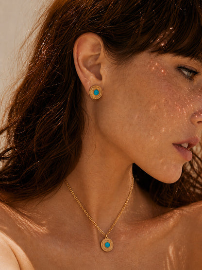 A lifestyle shot of the Jadeite drop earrings worn by a model. The visual demonstrates the graceful sway of the natural jade stones and how the 18K gold finish adds a warm, sun-kissed glow to a sophisticated daytime look.
