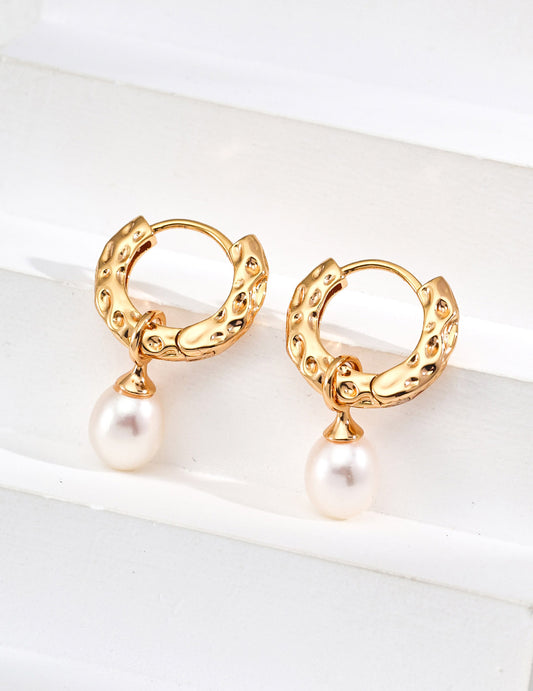 A clean studio shot of the Sylva earrings, showcasing the high-relief wood-grain etching and the creamy orient of the 8-10mm natural pearls.