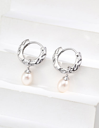 A professional shot of the Sylva earrings in Platinum Silver, emphasizing the sleek, modern feel of the S925 sterling silver and the cool-toned luster of the pearls.