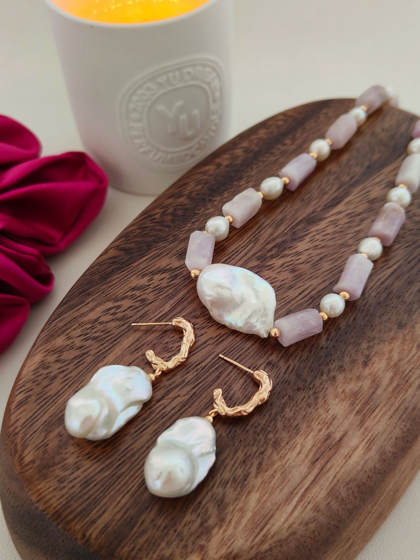 A flat lay photo of the Calliope earrings paired with a matching baroque pearl necklace, demonstrating a cohesive luxury pearl jewelry set for brides or statement-seekers.